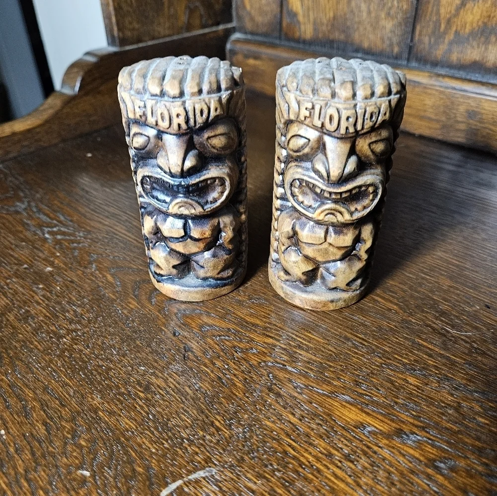 Set of vintage Florida ceramic tiki salt and pepper shakers.